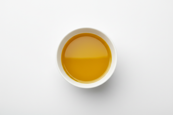 argan oil in a white bowl with white background